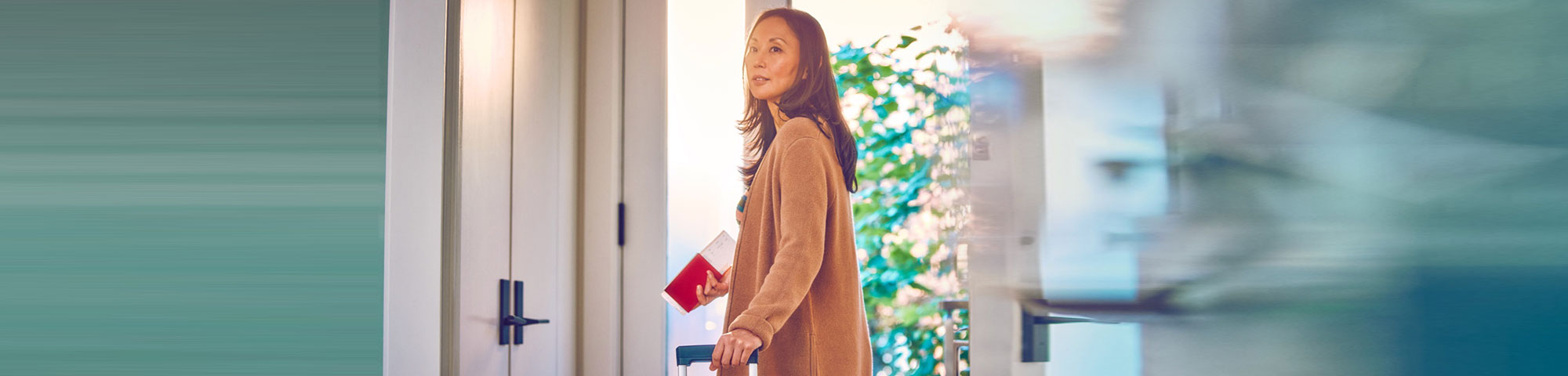 A woman holding travel documents.